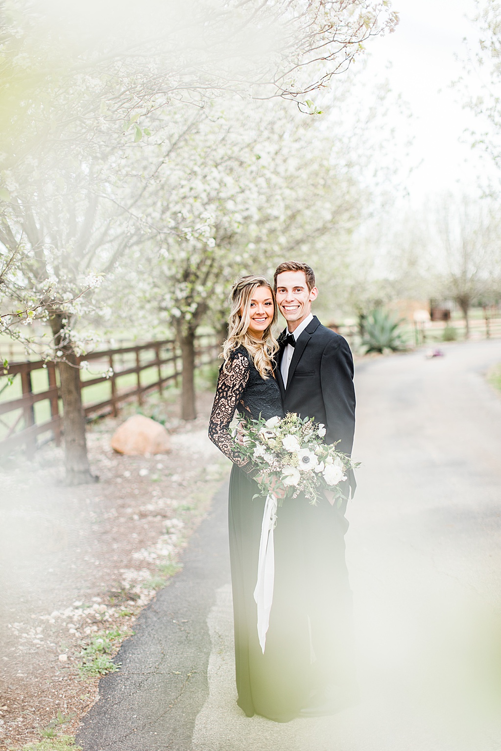 King River Ranch Wedding Venue in Johnson City Engagement Photos in the white Pear blossoms by Allison Jeffers Wedding Photography 0011
