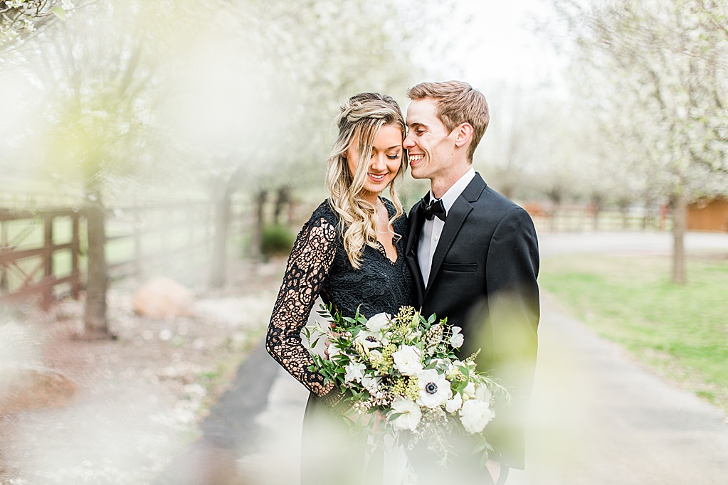 King River Ranch Wedding Venue in Johnson City Engagement Photos in the white Pear blossoms by Allison Jeffers Wedding Photography 0016