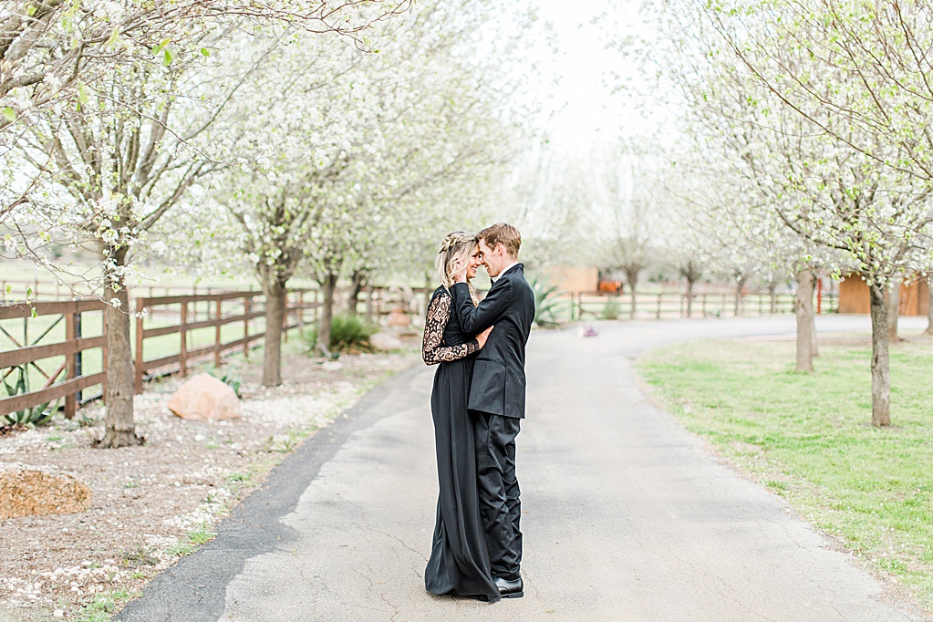 King River Ranch Wedding Venue in Johnson City Engagement Photos in the white Pear blossoms by Allison Jeffers Wedding Photography 0026