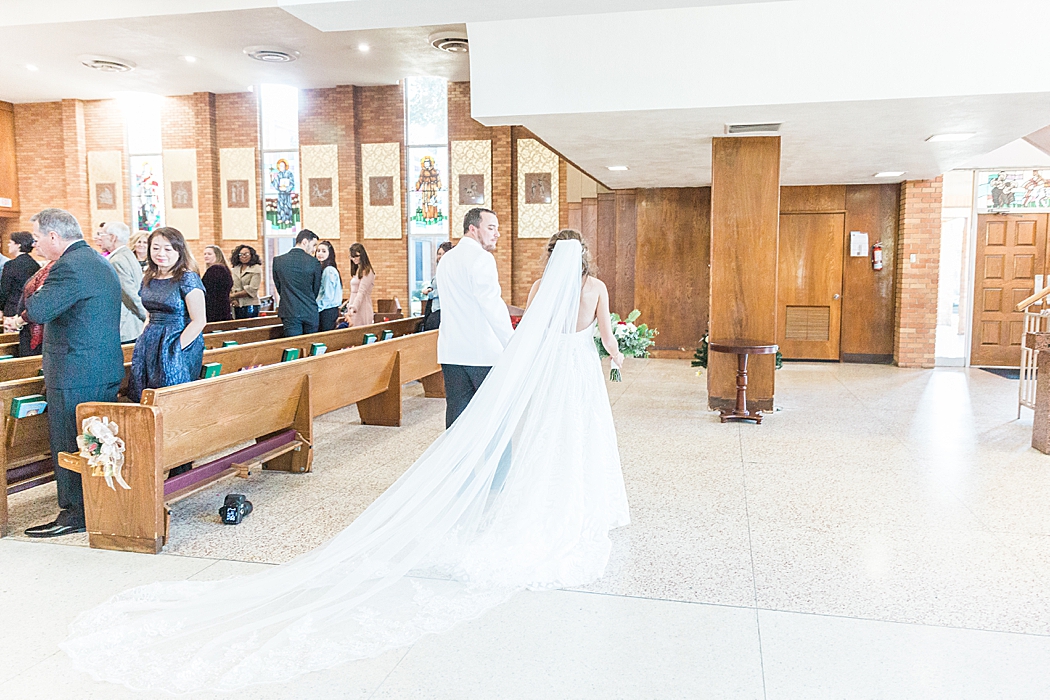 Chandelier of gruene reception and St. John the Evangelist Catholic Church in San Marcos, Tx wedding ceremony 0058